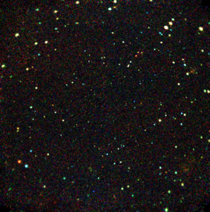 This Chandra image shows that gigantic black holes were much more active in the past than the present. In this deepest X-ray exposure ever made, some of the sources are 12 billion light years away. Most of the objects are active galaxies and quasars powered by supermassive black holes, while other objects are galaxies, and groups and clusters of galaxies. Information from this image will help astronomers understand how dense clouds of gas form galaxies with massive black holes at their centers. The energy bands of the X-rays are color coded, with red representing lower energies, yellow intermediate, and blue the highest energies.