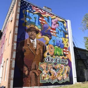 Colorful Elijah Cummings mural on the side of a building