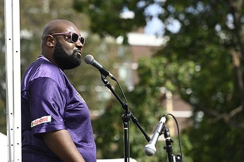 Man in a Ravens jersey with a microphone