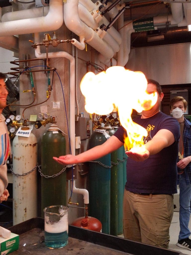 Prof. Tyrel McQueen in a handheld fire safety demonstration