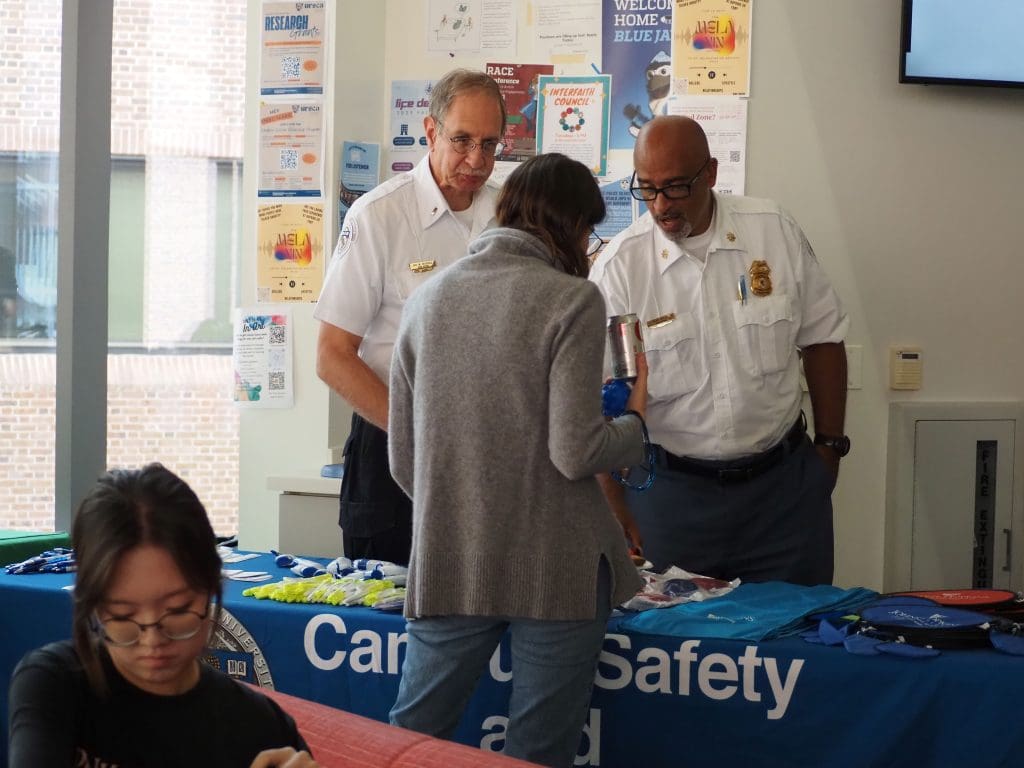 Campus Safety officers speak to a student