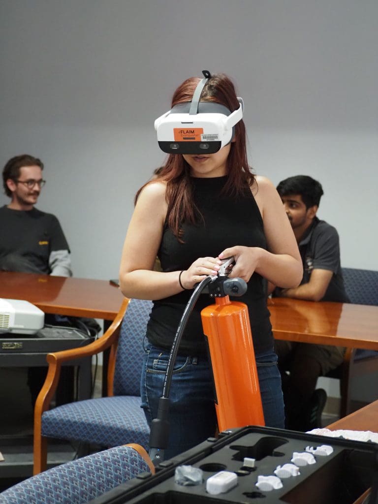 A student in VR firefighting gear