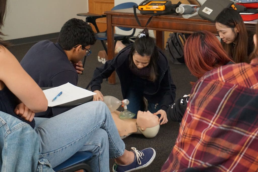 CPR training group with bag valve mask