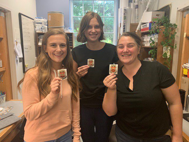 Casey, Alyssa, and Leslie showing off their junior firefighting badges