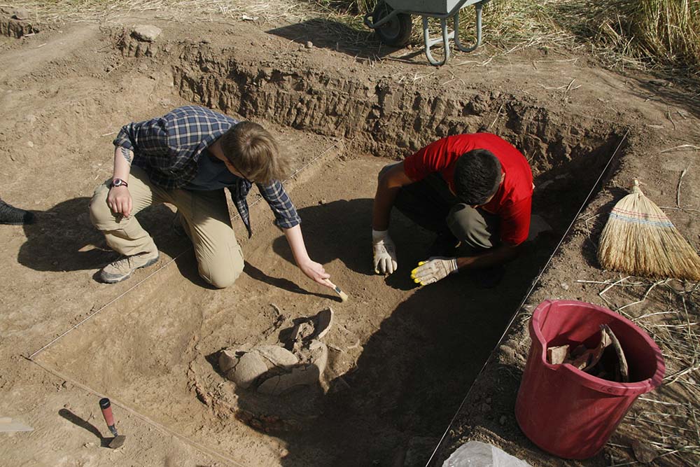 Excavating oven with broken pottery inside