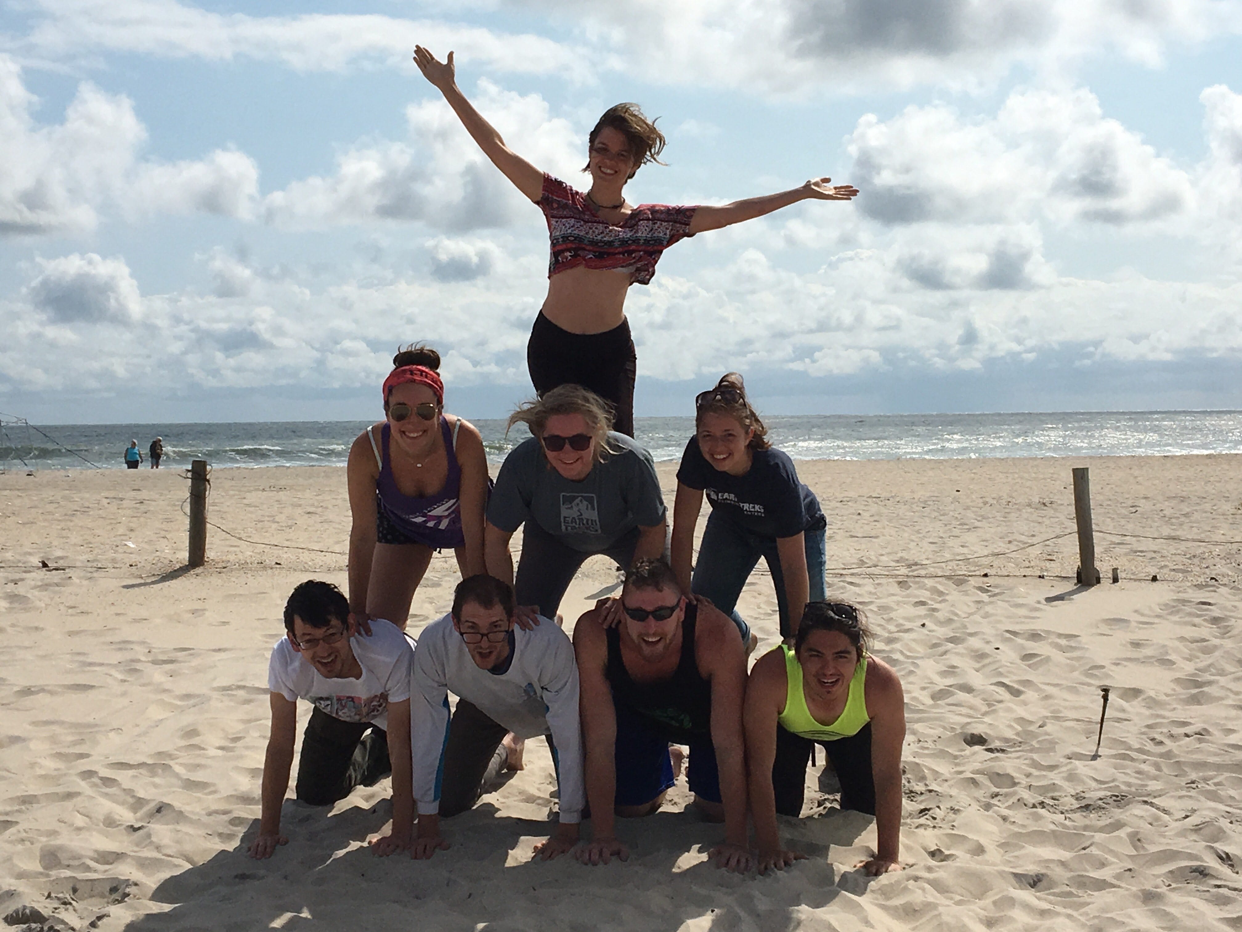 Human pyramid with eight people on a beach