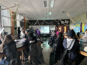 A photograph of MInDS presenting to high school students on immunity and antigen-based assays