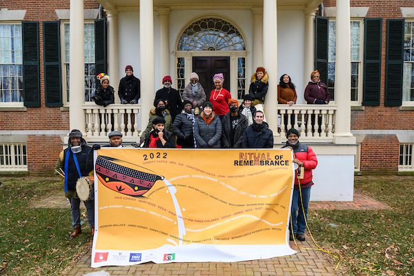 Photo of Inheritance Baltimore team holding Ritual of Remembrance banner.