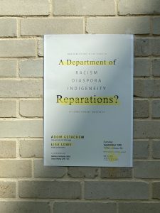 Poster for "A Department of Reparations?" attached to beige brick wall with shadow over it at a 45 degree angle