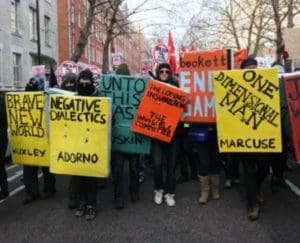 "Book Bloc" marching with yellow, red, and green book shields held aloft