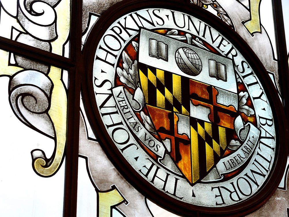 JHU shield in stained glass
